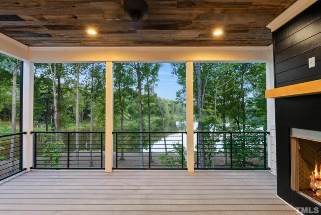 a view of an empty room and kitchen view