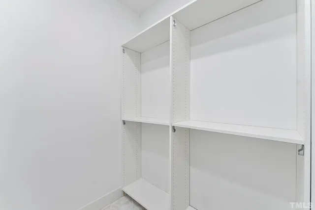 a living room with fireplace furniture and a rug