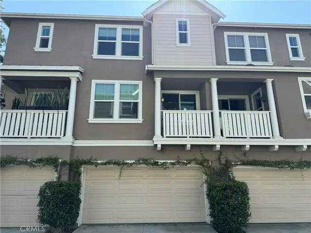 a front view of a house with a tree