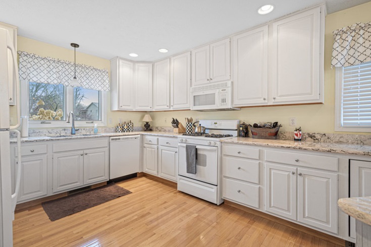 834 Breckenboro Road Lake Summerset, IL 61019 - Photo 15 of 39 a kitchen with granite countertop white cabinets and white appliances with wooden floor