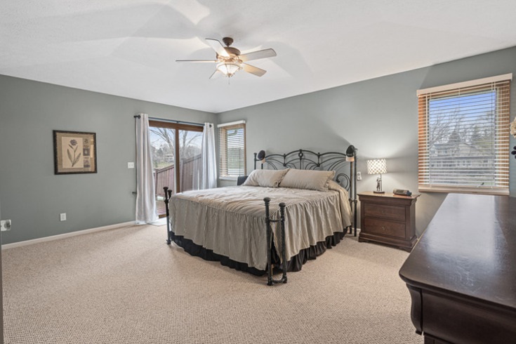 834 Breckenboro Road Lake Summerset, IL 61019 - Photo 19 of 39 a spacious bedroom with a bed a couch and a chandelier