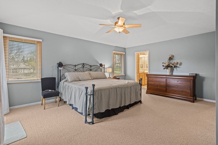 834 Breckenboro Road Lake Summerset, IL 61019 - Photo 22 of 39 a bedroom with a bed and a chandelier