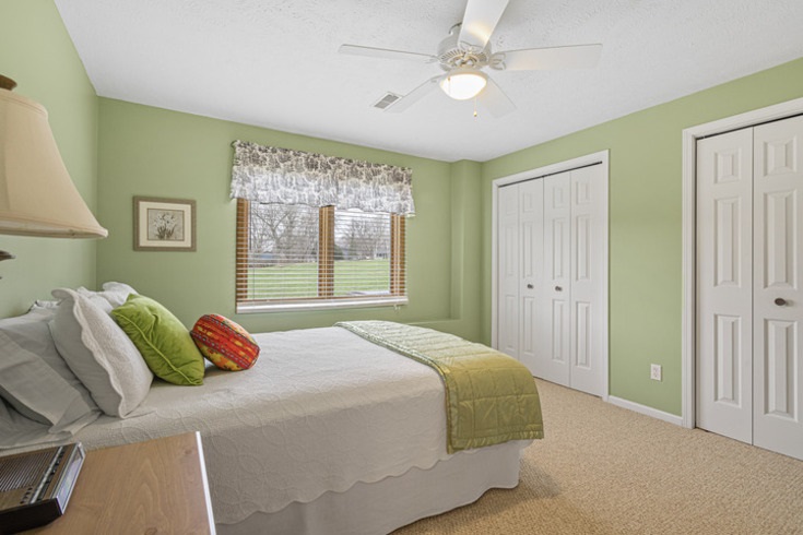 834 Breckenboro Road Lake Summerset, IL 61019 - Photo 29 of 39 a bedroom with a bed and a chandelier