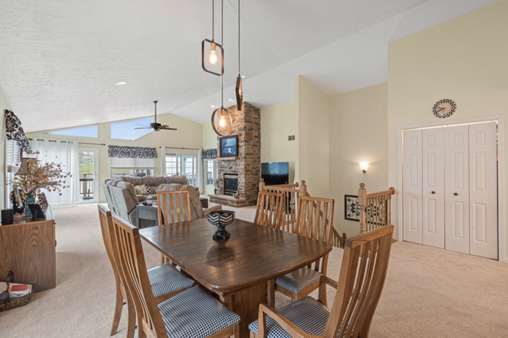834 Breckenboro Road Lake Summerset, IL 61019 - Photo 5 of 39 a view of a dining room and livingroom with furniture wooden floor a rug a fireplace and a chandelier