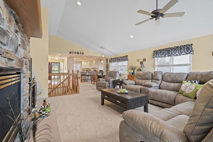 834 Breckenboro Road Lake Summerset, IL 61019 - Photo 9 of 39 a living room with furniture ceiling fan and a fireplace