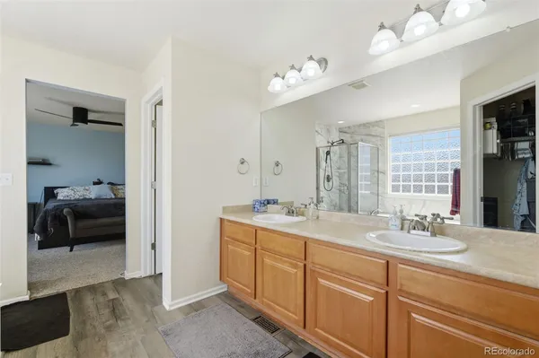 a en suite bathroom with double sink a mirror and a shower