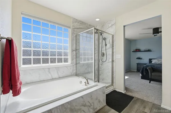 a spacious bathroom with a tub shower and a sink