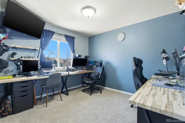 a workspace with furniture and a wooden floor