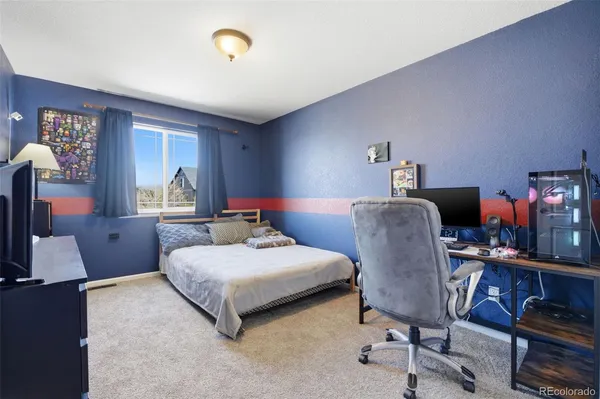 a bedroom with a bed and a desk