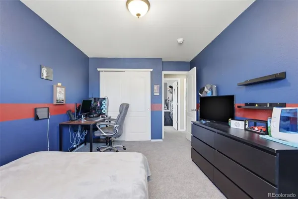 a bedroom with a workspace