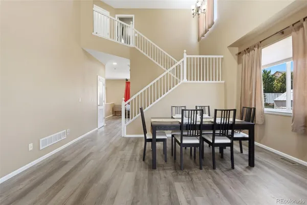 a dining room with furniture window and wooden floor