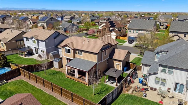 an aerial view of multiple houses with a yard