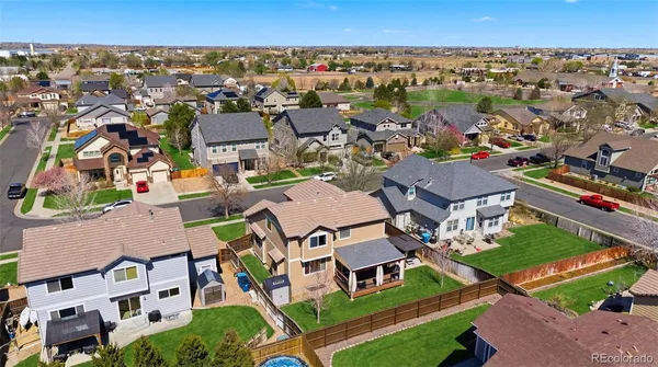 an aerial view of residential houses with outdoor space and parking