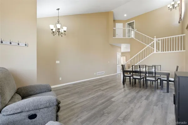 a dining room with furniture and wooden floor