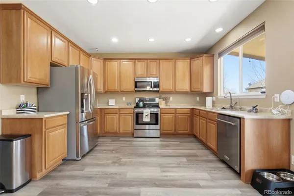 a kitchen with stainless steel appliances a refrigerator sink and cabinets