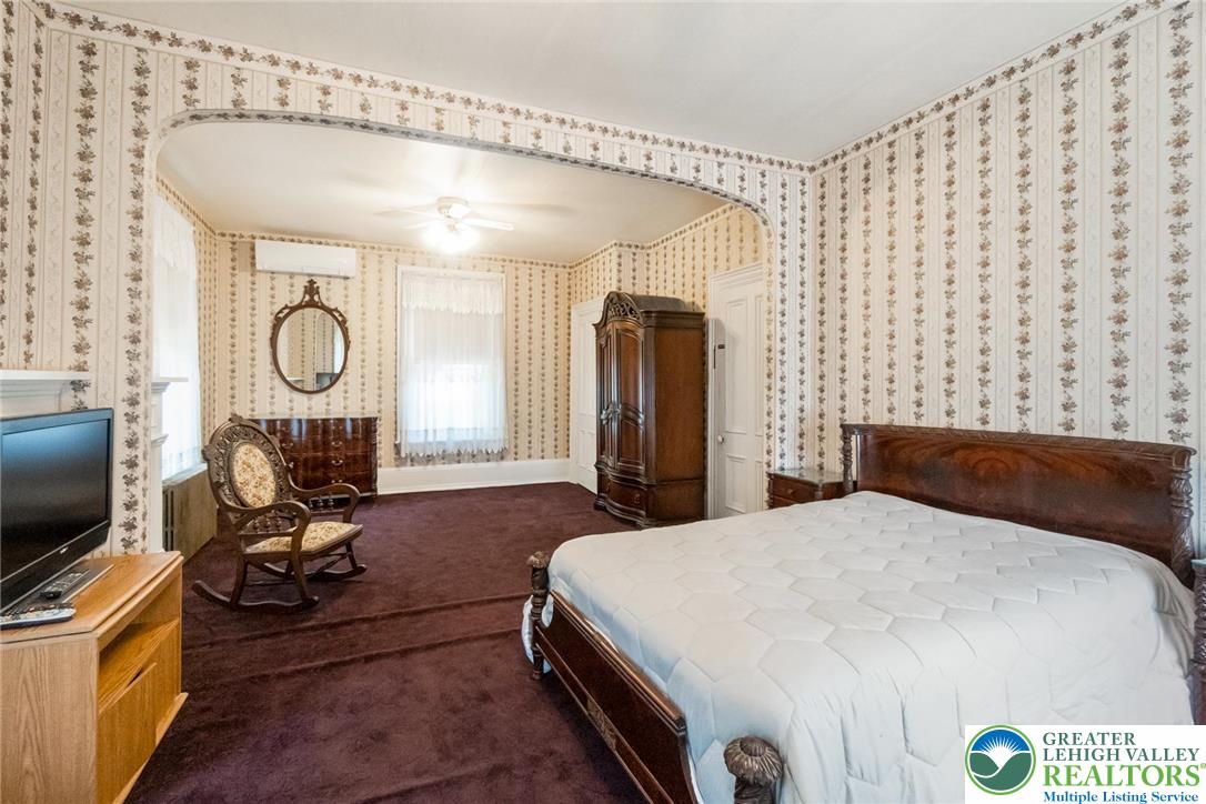 11 East Front Street Jim Thorpe, PA 18229 - Photo 51 of 63 a bedroom with a bed mirror and a large window