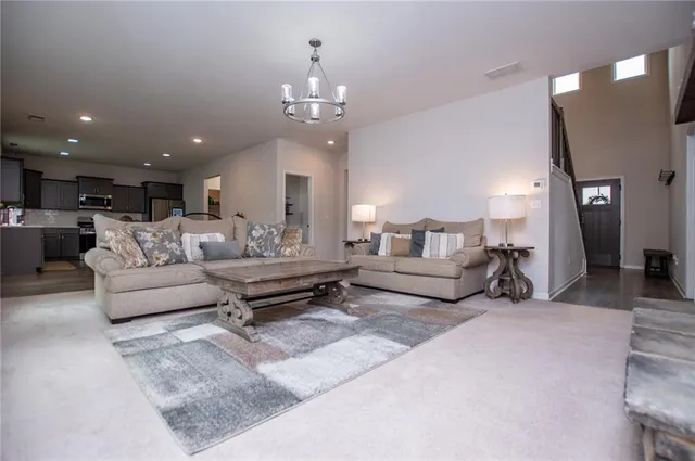 a living room with furniture and a chandelier