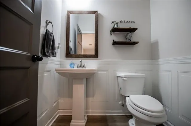 a kitchen with stainless steel appliances granite countertop wooden floors a stove and a refrigerator