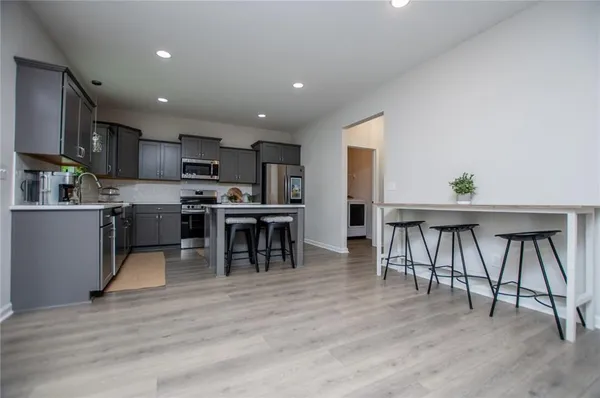 a kitchen with stainless steel appliances granite countertop cabinets a sink and a microwave