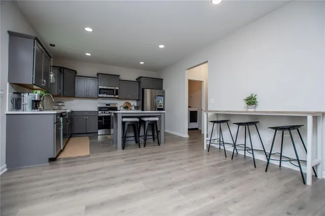 a kitchen with stainless steel appliances granite countertop cabinets a sink and a microwave