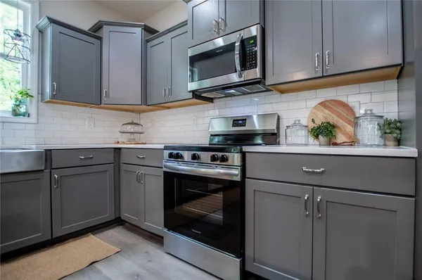 a kitchen with stainless steel appliances granite countertop a stove and a microwave