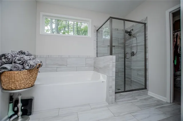 a spacious bathroom with a granite countertop sink and a mirror
