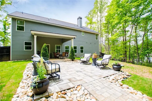 a view of a house with backyard sitting area and garden