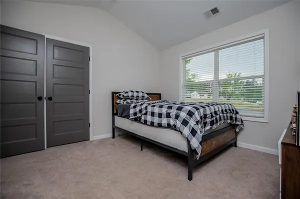 a bedroom with a bed and a couch