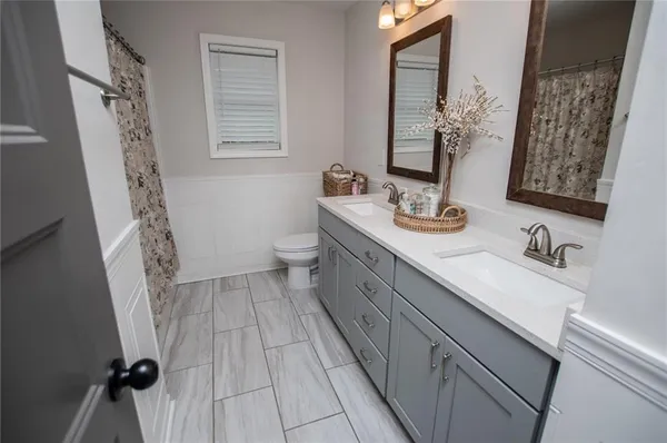 a bathroom with a sink vanity and mirror