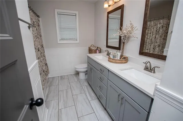 a bathroom with a sink vanity and mirror