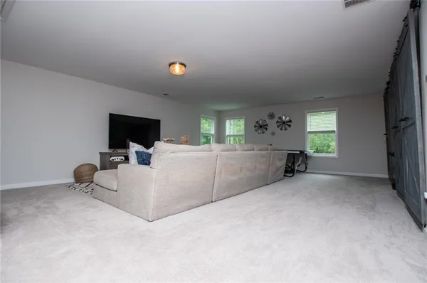 a view of a room with wooden floor and windows