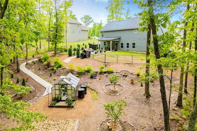 an aerial view of a swimming pool with a garden