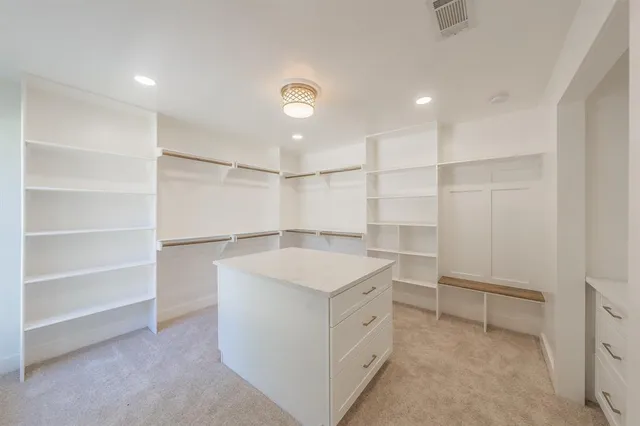 a storage & utility room with cabinets
