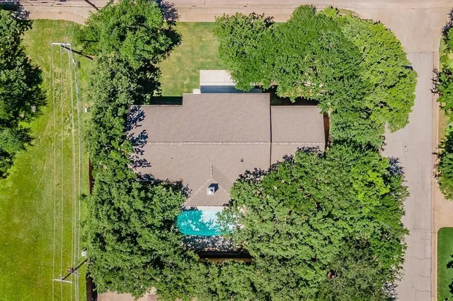 an aerial view of a house with a yard and garden space