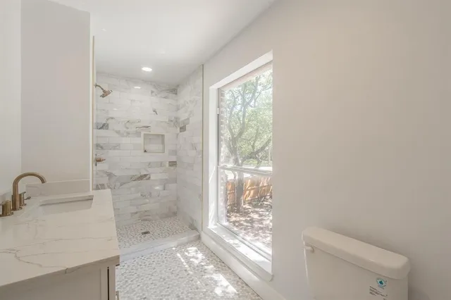 a bathroom with a shower sink and toilet