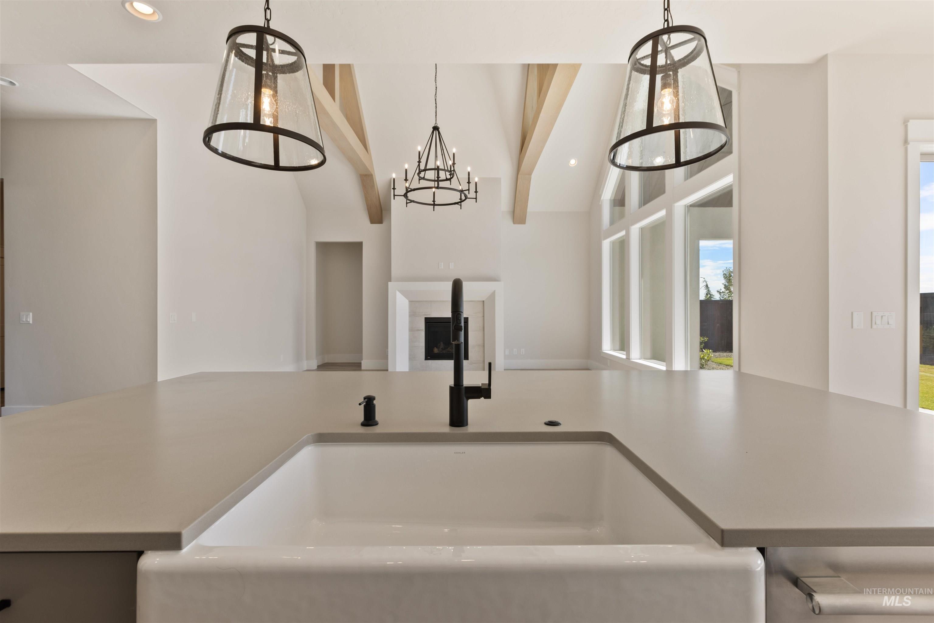 5857 South Highmark Avenue Meridian, ID 83642 - Photo 36 of 37 Kitchen featuring pendant lighting, recessed lighting, vaulted ceiling, open floor plan, and a chandelier