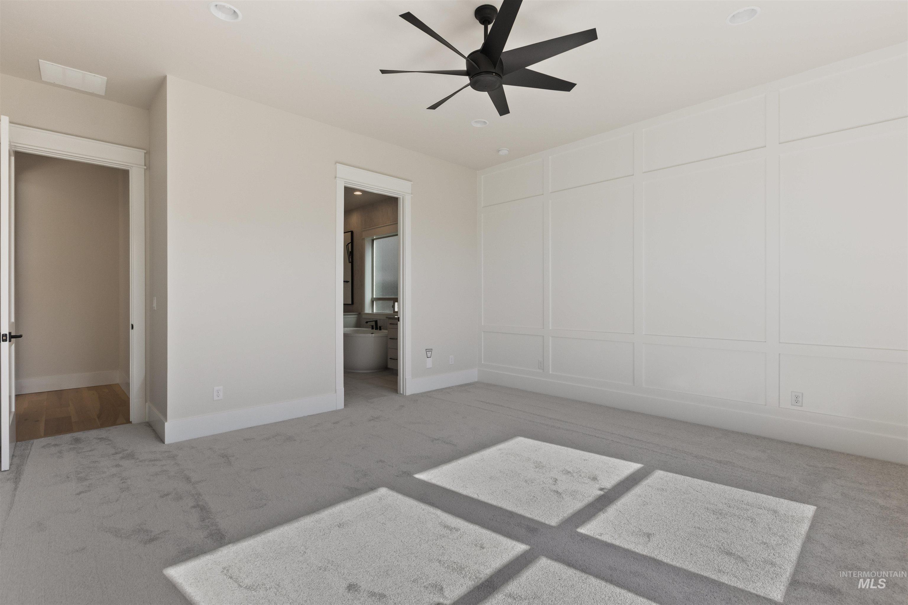 5857 South Highmark Avenue Meridian, ID 83642 - Photo 15 of 37 Unfurnished bedroom with light carpet, ensuite bathroom, and a ceiling fan