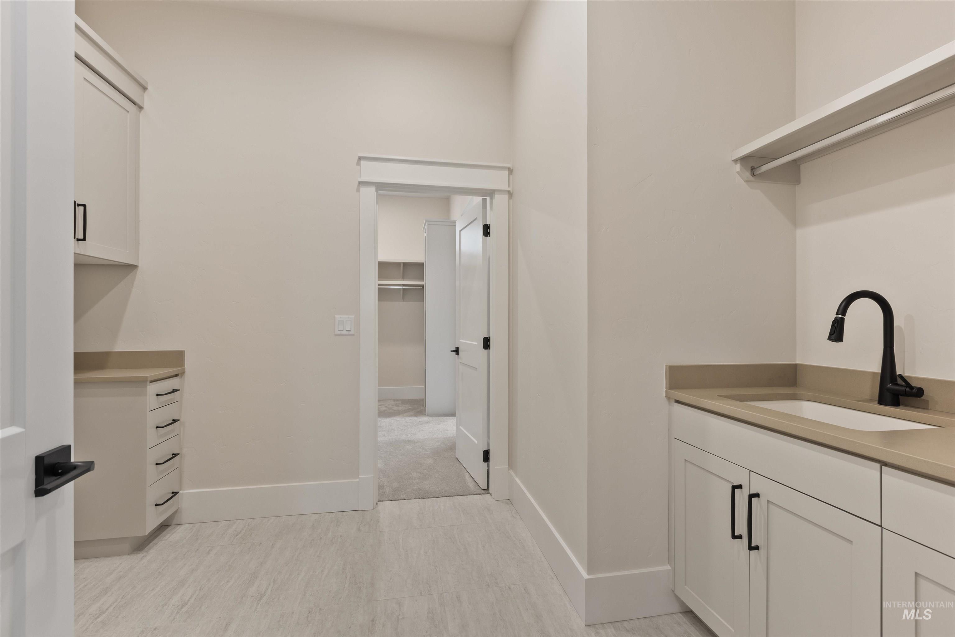 5857 South Highmark Avenue Meridian, ID 83642 - Photo 23 of 37 Laundry room featuring a sink and baseboards