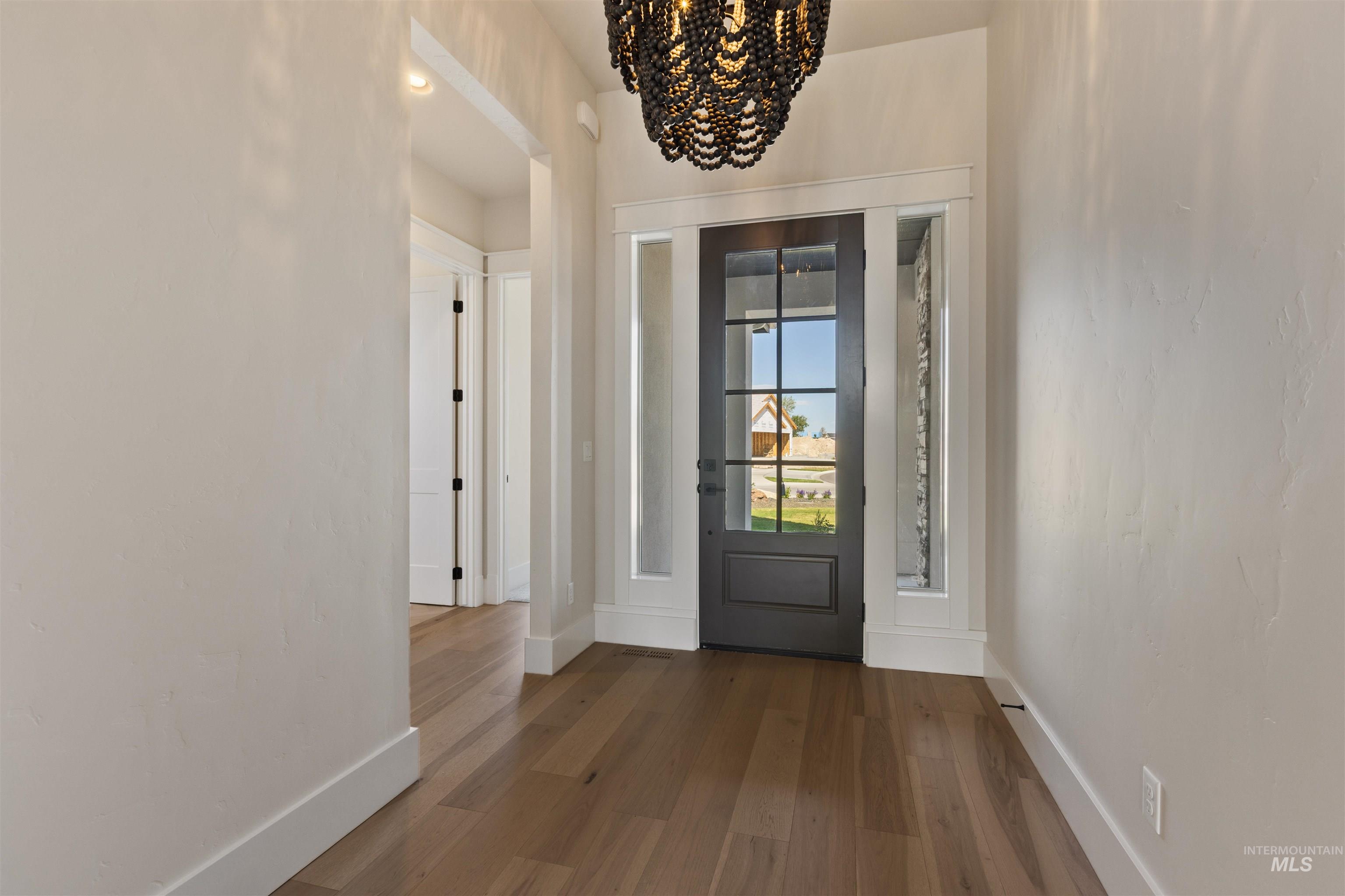5857 South Highmark Avenue Meridian, ID 83642 - Photo 26 of 37 Entrance foyer with a chandelier and wood finished floors