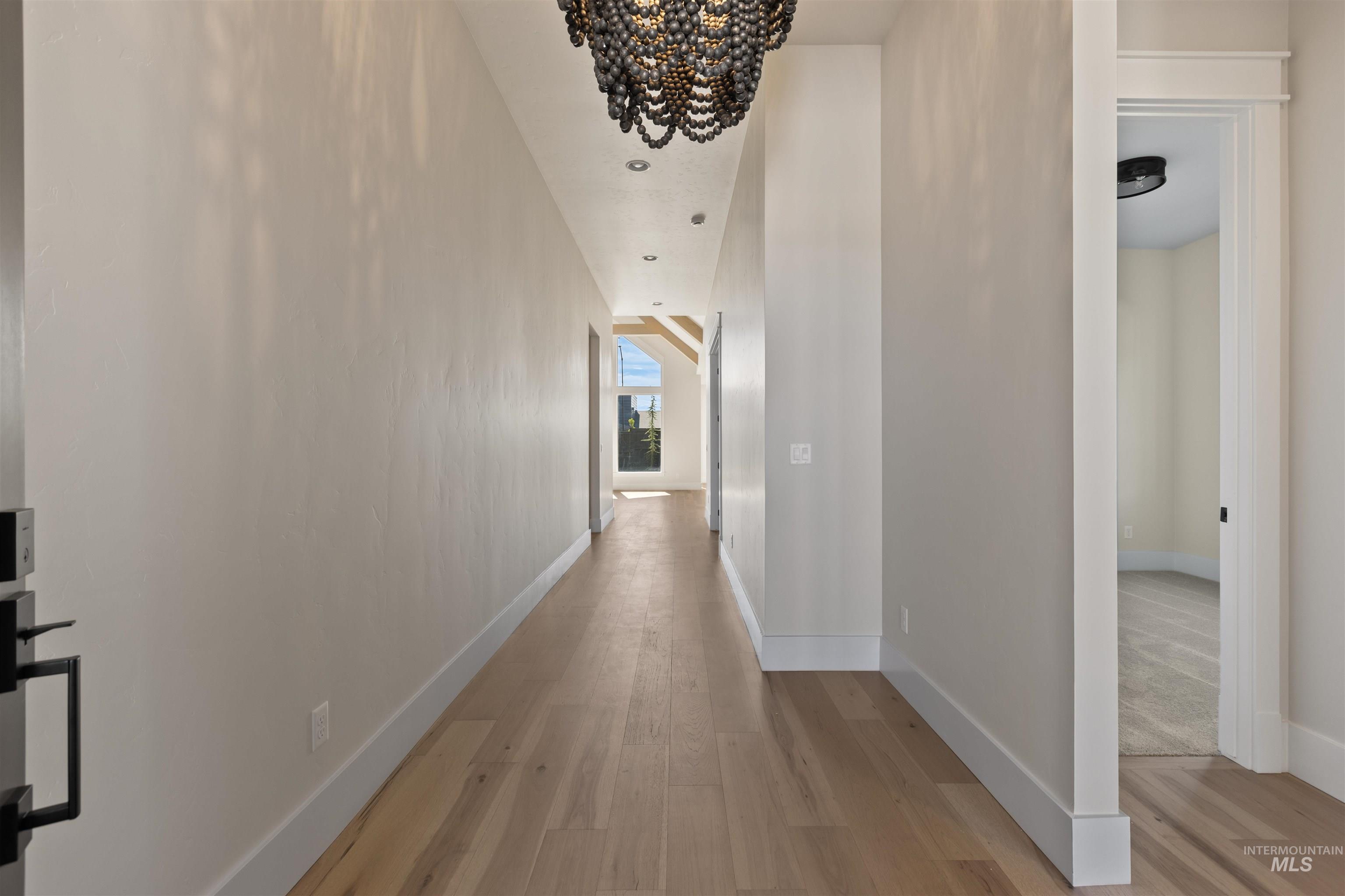 5857 South Highmark Avenue Meridian, ID 83642 - Photo 27 of 37 Hallway with light wood-type flooring and a chandelier