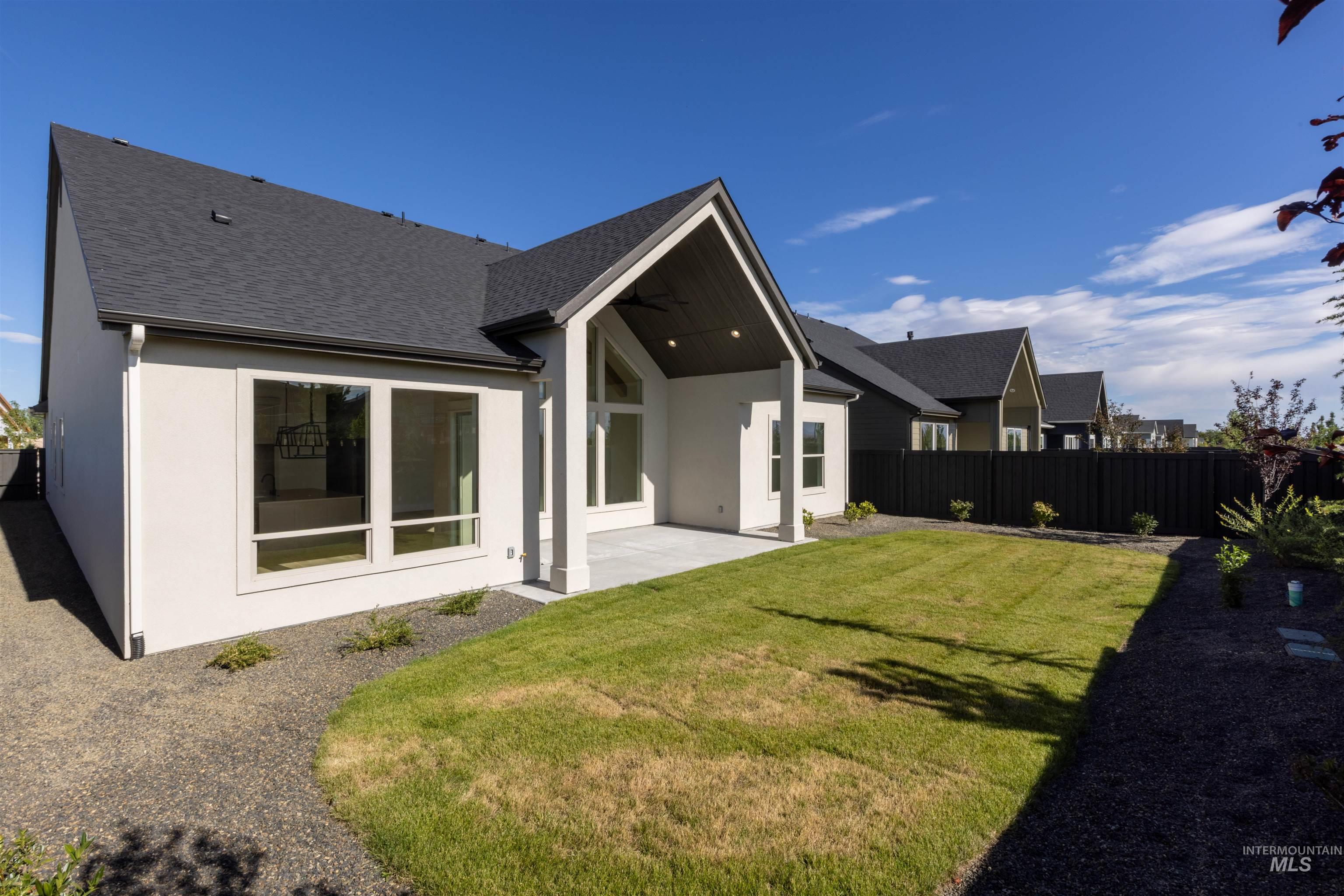 5857 South Highmark Avenue Meridian, ID 83642 - Photo 34 of 37 Rear view of property featuring stucco siding, a patio area, roof with shingles, and ceiling fan