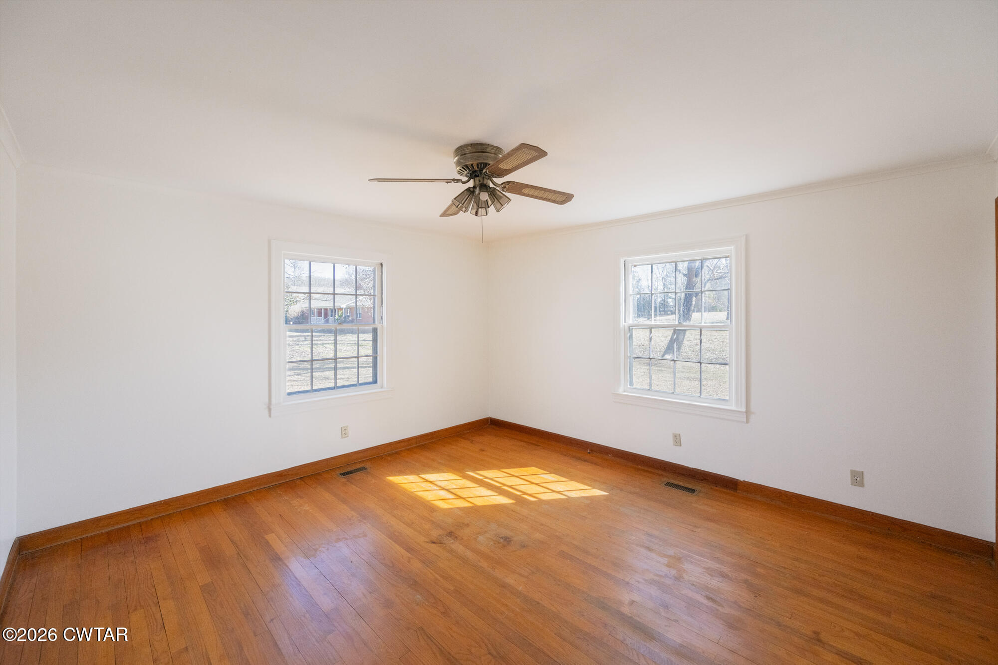 18810 West Main Street Huntingdon, TN 38344 - Photo 17 of 34 an empty room with wooden floor and windows
