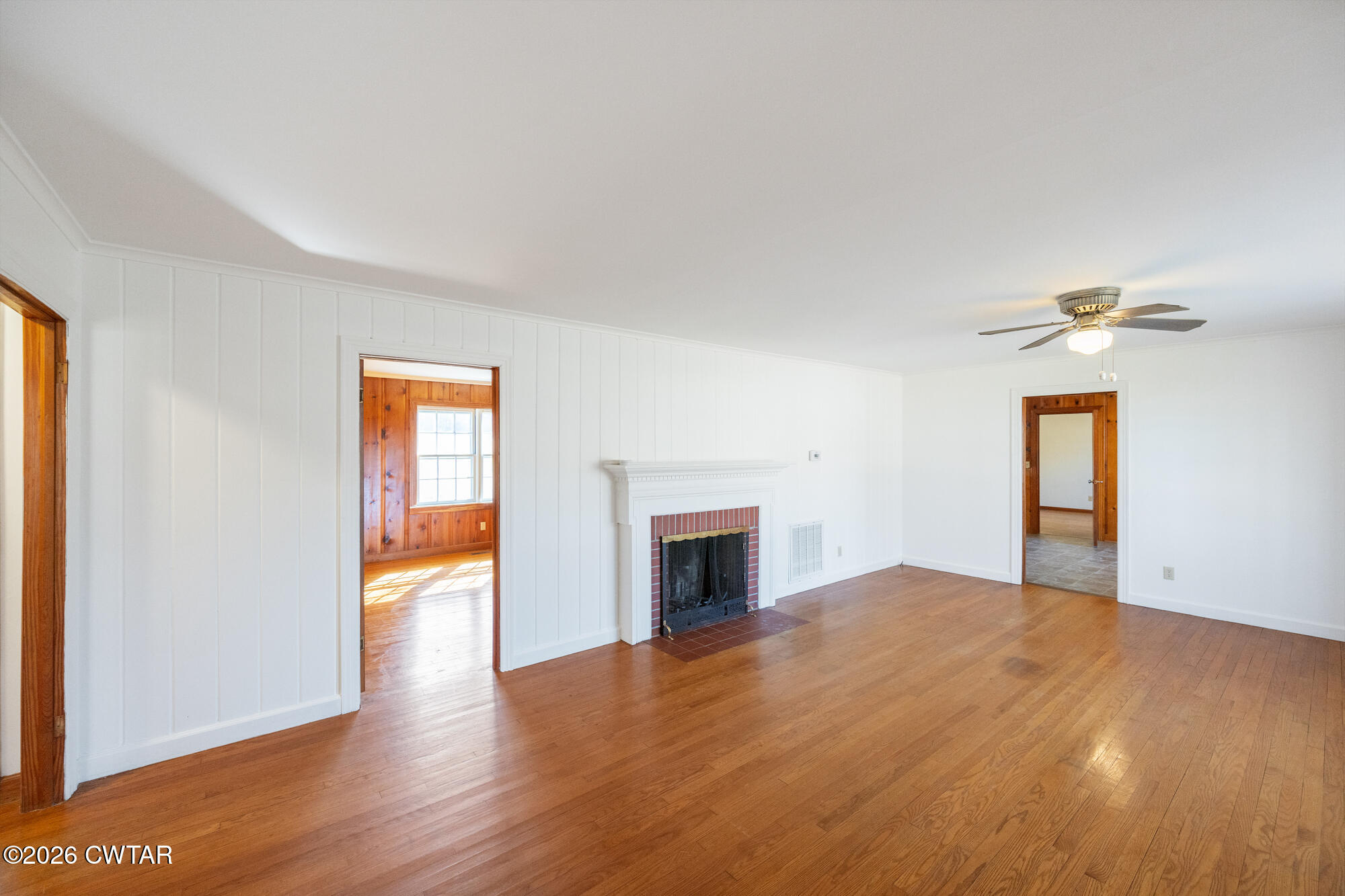 18810 West Main Street Huntingdon, TN 38344 - Photo 9 of 34 a view of empty room with wooden floor and fireplace