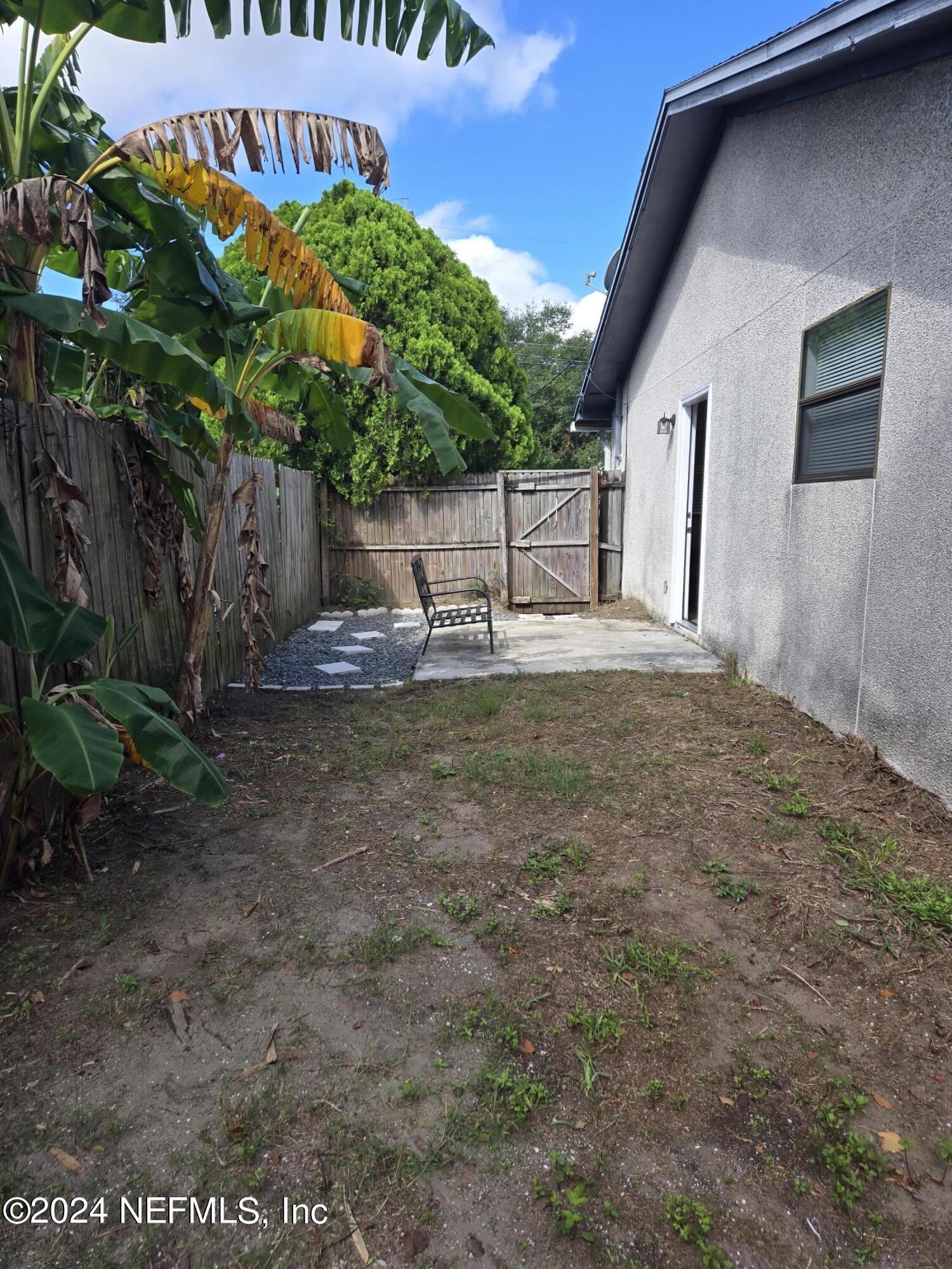 1055 Stocks Street Atlantic Beach, FL 32233 - Photo 14 of 15 a backyard of a house with plants and tree