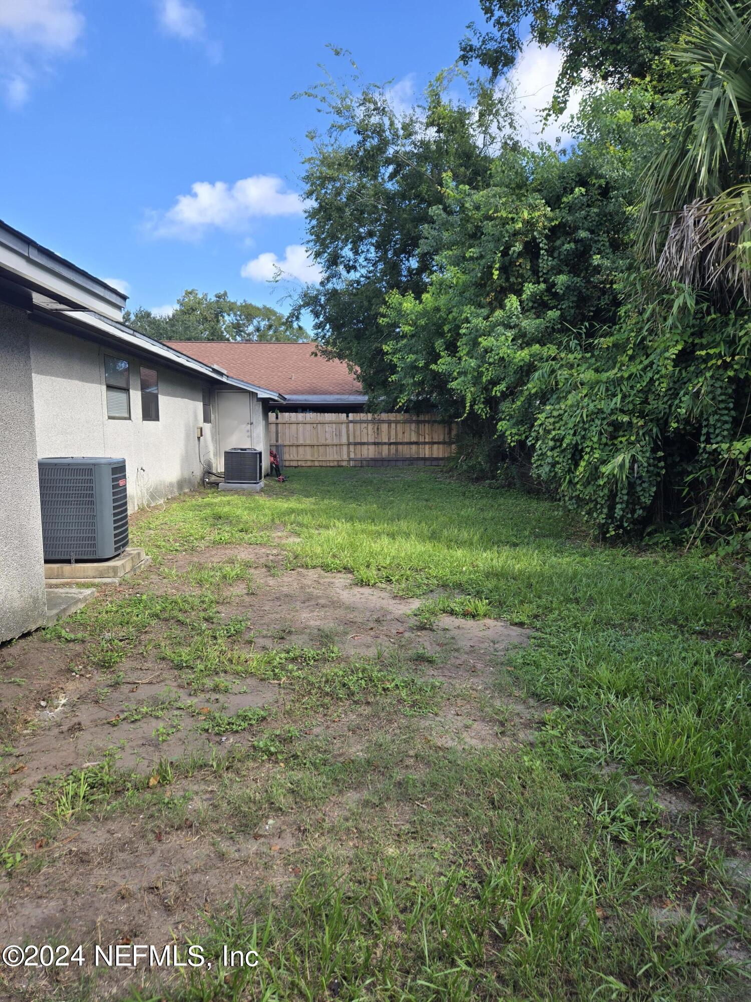 1055 Stocks Street Atlantic Beach, FL 32233 - Photo 15 of 15 a backyard of a house with plants and a garden
