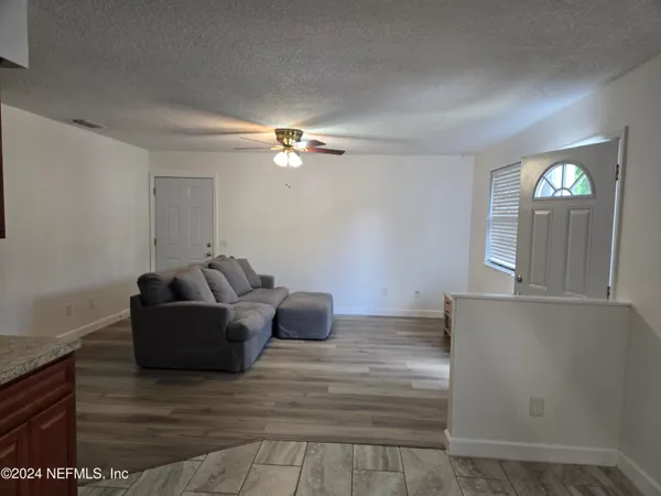 a living room with furniture and a lamp