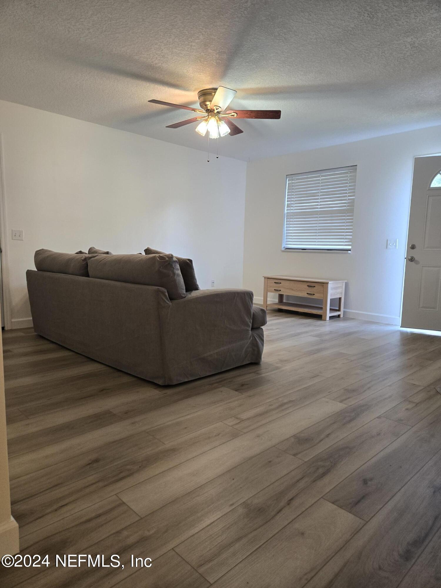 1055 Stocks Street Atlantic Beach, FL 32233 - Photo 6 of 15 a living room with furniture and a wooden floor
