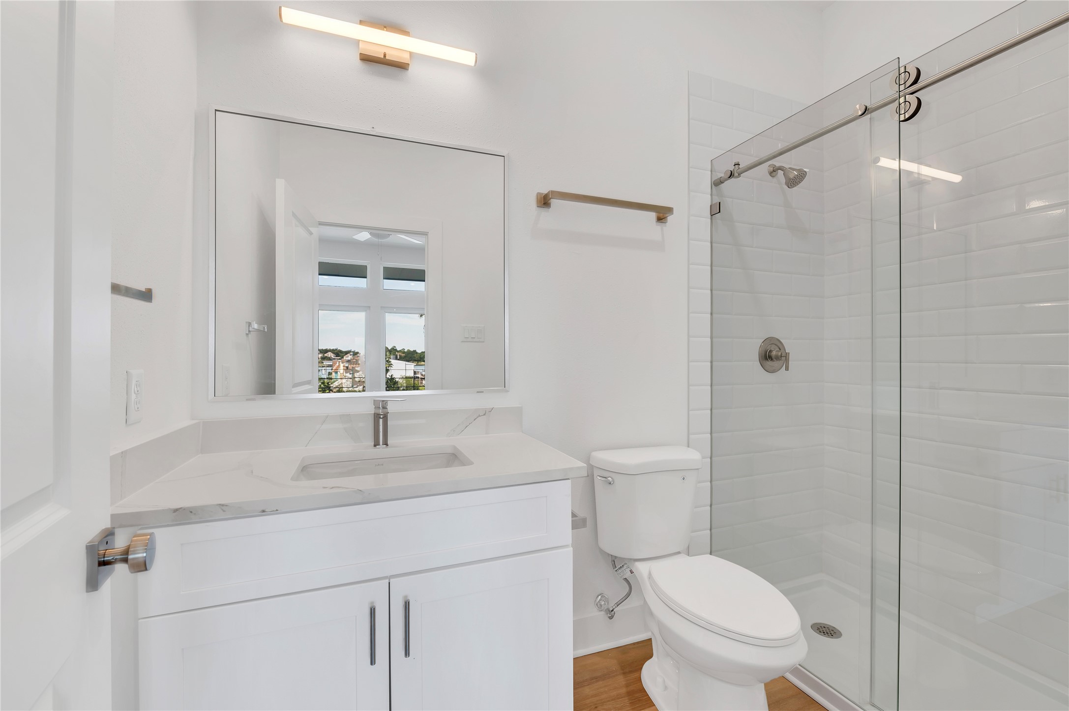 119 Kirby Road, Unit 5205 Seabrook, TX 77586 - Photo 41 of 46 Bright and modern bathroom featuring a sleek vanity with a marble countertop, a spacious glass-enclosed shower, and elegant lighting fixtures.