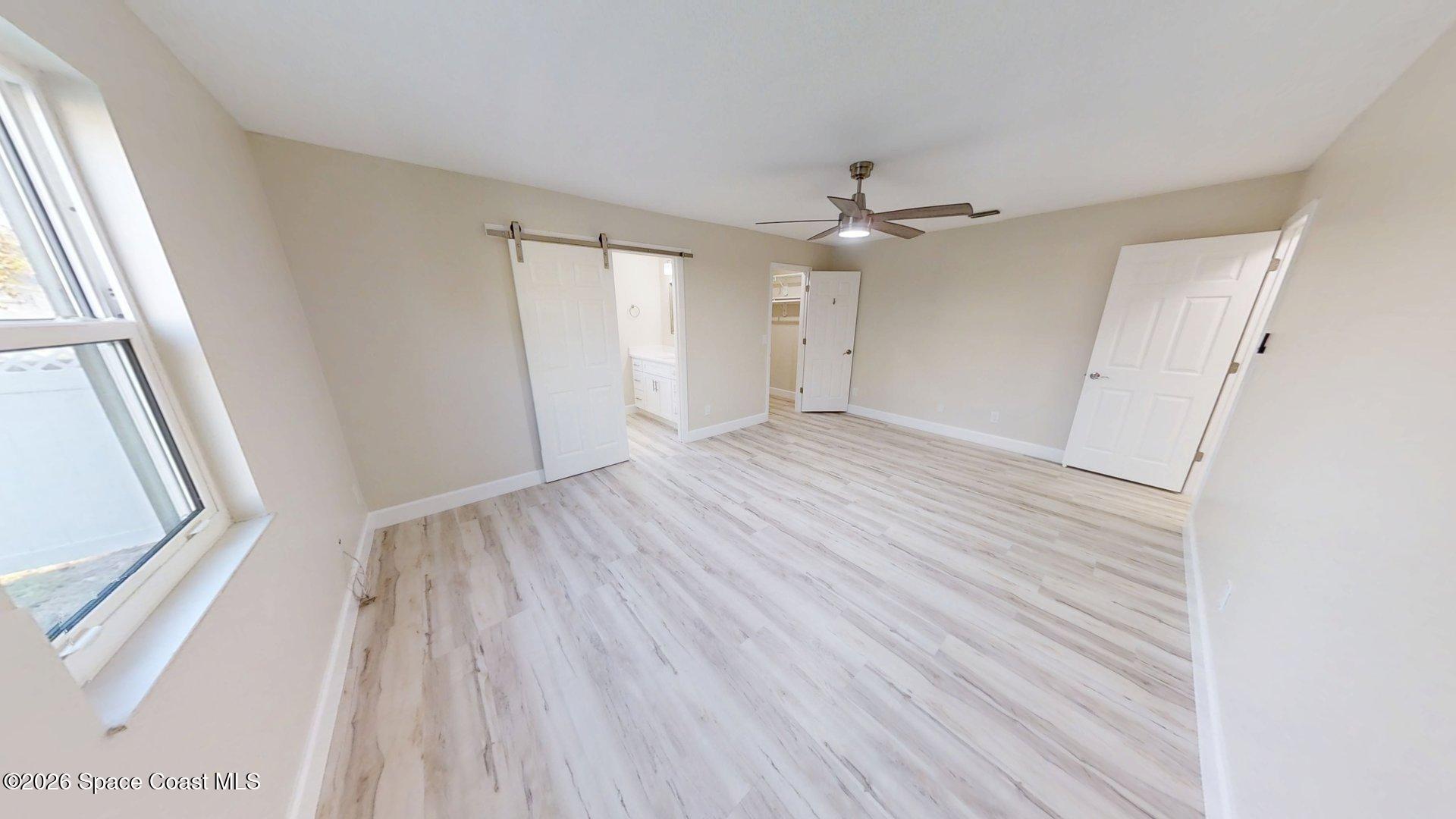 137 Concha Drive Sebastian, FL 32958 - Photo 13 of 29 wooden floor in an empty room with a window
