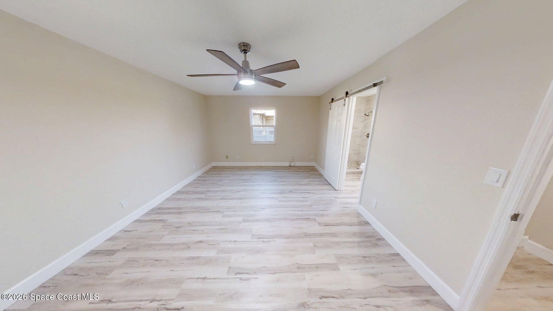 137 Concha Drive Sebastian, FL 32958 - Photo 14 of 29 a view of a hallway with wooden floor and a ceiling fan